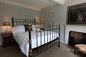a bedroom with a bed and a fireplace at Rock House BNB in Bakewell