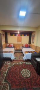 a room with four beds and a rug at Paul's stay in Darjeeling +23 photos