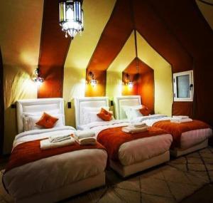 a room with two beds in a room with a room at Merzouga Nice luxury Camp in Merzouga