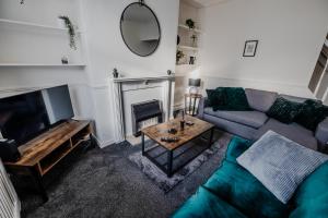 a living room with a couch and a table at The Nest at Blackburn in Cherry Tree