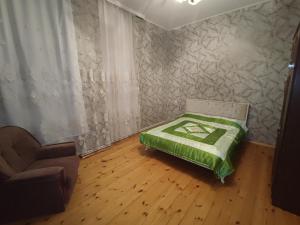 a room with a bed and a chair in it at Sheki city villa in Sheki