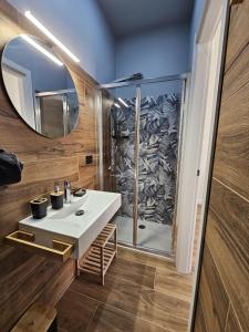 a bathroom with a sink and a shower at La Casa di Ray e Anto in Cassibile