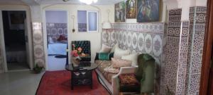 a living room with a couch and a table at Dar Ryma in El Jadida