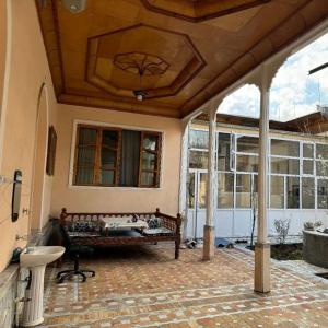a patio with a bench and a tub in a house at willa hostel in Yunusobod
