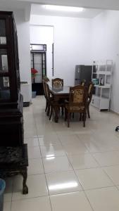 a dining room with a table and chairs on a tile floor at KJ HOMESTAY SUNGAI PETANI in Sungai Petani