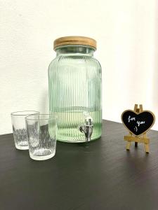 a glass jar sitting on a table next to a glass at Casa Ganza in Pisa +13 photos