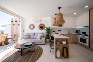 a kitchen and living room with a couch and a table at Casa Breca in Puerto del Carmen