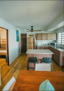 a large kitchen with a table and chairs in it at Ocean Front Villa 3 in Culebra