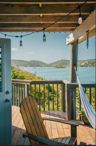a hammock on a deck with a view of the water at Ocean Front Villa 3 in Culebra +6 photos