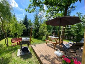 a wooden deck with a table and an umbrella at Physio House Sokolik in Komarno