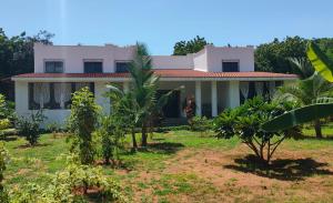 a house with a garden in front of it at Malaica in Kilifi