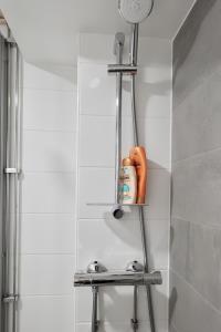 a shelf in a bathroom with a shower at Relax by the Sea 4 Min to Beach Free Parking in Helsinki