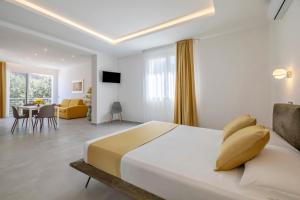 a bedroom with a large bed and a dining room at Case Vacanza Loria in Castelluzzo