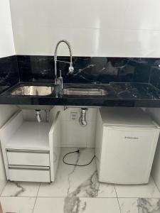 a kitchen with a sink and a counter at JBR HOTEL RESIDENCE in Goiânia