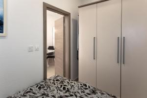 a bedroom with white cabinets and a bed at Moon Apartment in Split