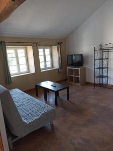 a living room with a couch and a coffee table at La Grange in Roquemaure