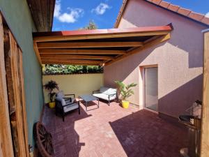 a patio with a wooden pergola on a house at Ferienhof Gosen in Gosen