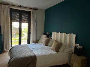 Postel nebo postele na pokoji v ubytování Hostal San Martin