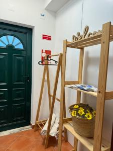 a room with a green door and a ladder at Nature House Almograve - Double Room with terrace and private bathroom - Fishermen's Trail in Almograve