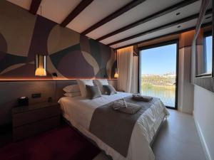 a bedroom with a large bed with a large window at CasaKary in Seville
