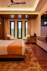 a bedroom with a bed and a kitchen with windows at Beyond Blu in Port Blair