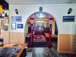 a room with an archway with beds in it at Paul's stay in Darjeeling