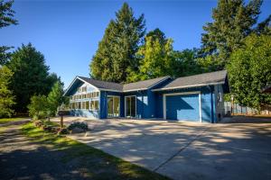 a blue house with a garage at Blue House - private 2 bed, 2 bath home with garage in Eugene