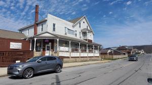 a gray car parked in front of a house at The Miners’ Lodge in Northern Cambria