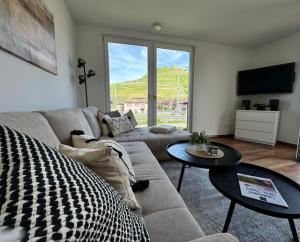 a living room with a couch and a table at Penthouse Burgblick mit Dachterrasse in Staufen im Breisgau