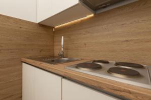 a kitchen with a stove and a sink at Ferienwohnung für 4 Personen ca 50 qm in Njivice, Kvarner Bucht Krk in Njivice