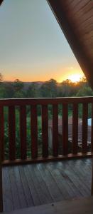 a view of the sunset from the deck of a house at Cabañas Refugio verde in El Soberbio