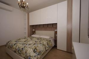 a bedroom with a bed and a chandelier at fiordaliso 1 in Milan