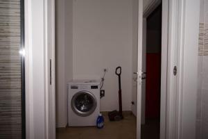 a laundry room with a washing machine and a washer at fiordaliso 1 in Milan +5 photos