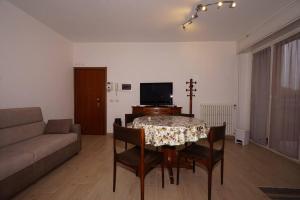 a living room with a table and chairs and a couch at fiordaliso 1 in Milan
