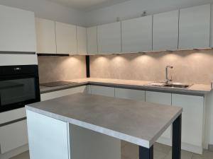 a kitchen with white cabinets and a counter top at KG Apartment in Hannover