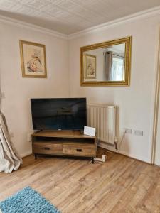 a living room with a large flat screen tv at Lovely 2-Bed House in the heart of Woodhouse Leeds in Leeds
