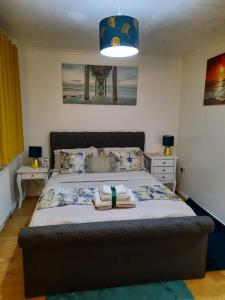 a bedroom with a large bed with two night stands at Lovely 2-Bed House in the heart of Woodhouse Leeds in Leeds