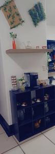 a room with blue shelves with food on them at La posada de nana in Alajuela City
