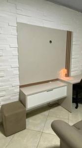 a white desk in a room with a wall at Casa aconchego in Feira de Santana