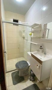 a bathroom with a shower and a toilet and a sink at Casa aconchego in Feira de Santana