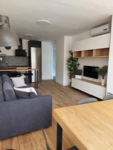 a living room with a couch and a table at Benidorm playa poniente in Benidorm