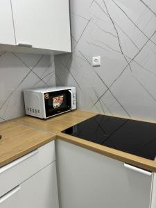 a toaster oven sitting on a counter in a kitchen at Квартира с новым ремонтом in Nahariyya