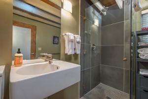 a bathroom with a sink and a shower at Casa Saint Francis- King Bed-Patio & Fire Pit -2BR in Santa Fe +19 photos