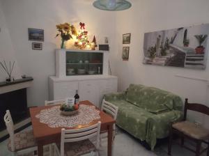 a living room with a table and a couch and a christmas tree at Ostuni holiday nature in Ostuni