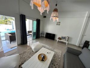 a living room with a couch and a table at Pool villa copacolanta in Ko Lanta