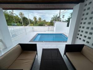 a patio with a swimming pool and two couches at Pool villa copacolanta in Ko Lanta