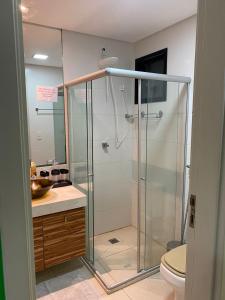 a bathroom with a shower with a toilet and a sink at Pajuçara Front Beach in Maceió