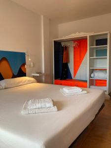 a large white bed with two towels on it at Casa Bonica in Palomares +35 photos