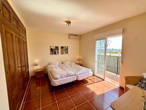 a bedroom with a bed and a large window at A 5 minutos de la playa casa de vacaciones con piscina privada in Puerto de Mazarrón