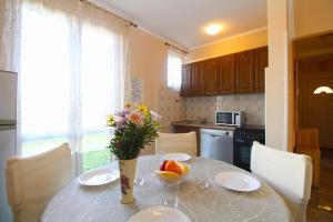 eine Küche mit einem Tisch mit einer Blumenvase in der Unterkunft Studio für 4 Personen ca 48 qm in Fažana, Istrien Istrische Riviera in Fažana